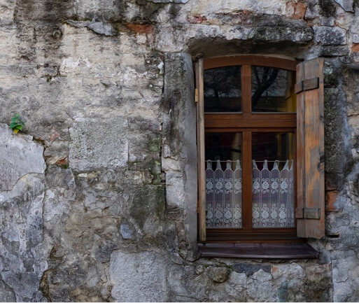 A stone wall with a wooden window